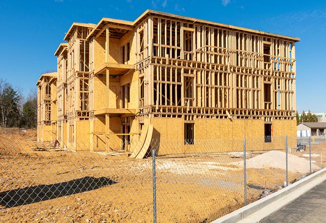 a construction site enclosed by temporary chain link fences, ensuring safety for workers and pedestrians in Ontario CA